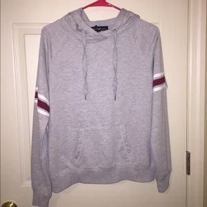 grey hoodie with red and white stripes on sleeve